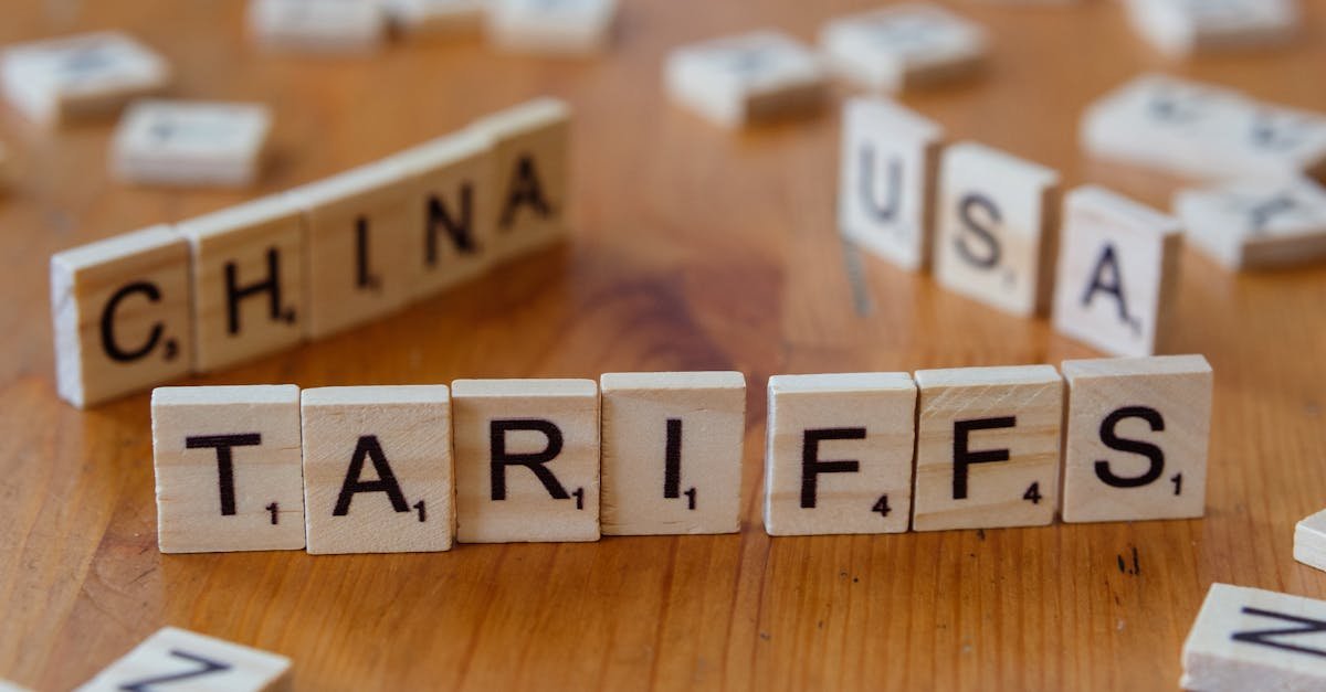 Wooden letter blocks spelling tariffs, China, and USA representing trade relations.