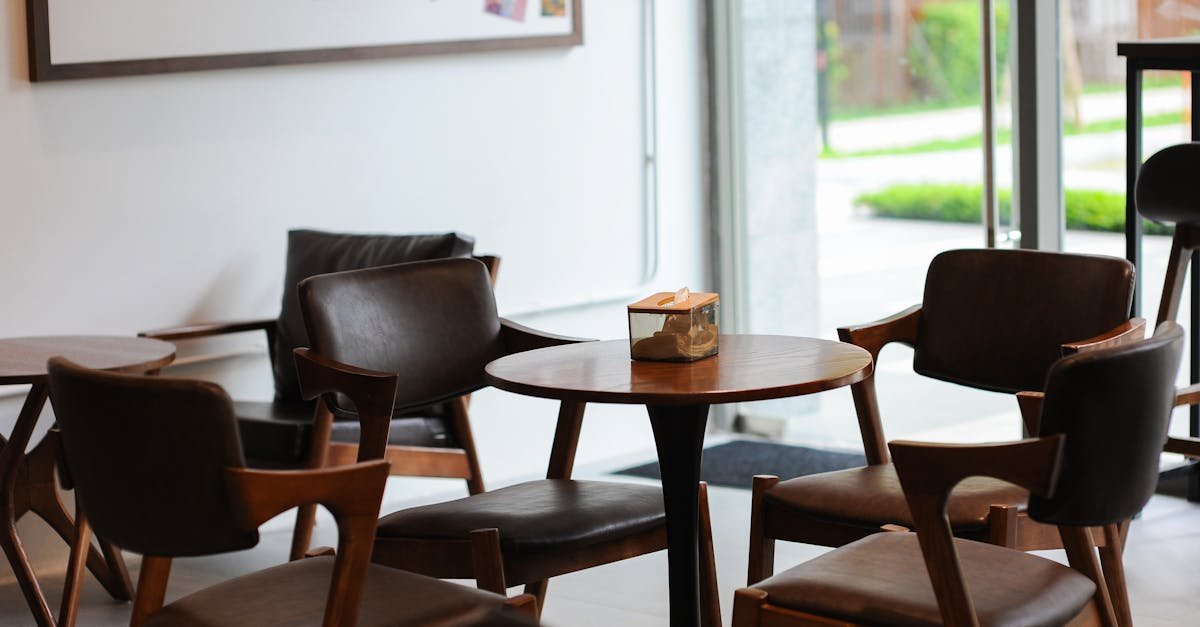 Warm and inviting coffee shop interior in Hà Nội, Việt Nam with modern wooden furniture and large windows.