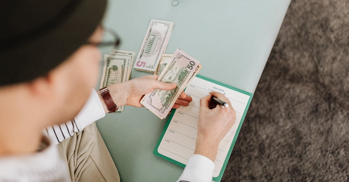 Individual budgeting with US dollars and a planner, focusing on financial planning.