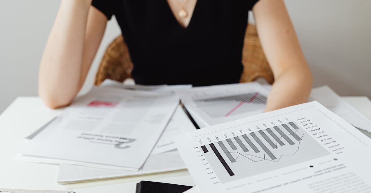 Close-up of financial documents and graphs on a desk, showcasing business analysis.